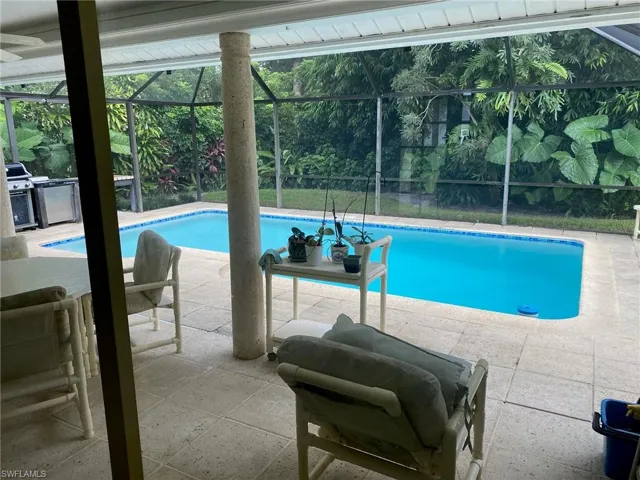 View of pool with a lanai and a patio area