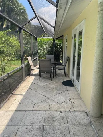 View of patio / terrace with outdoor dining space and a lanai