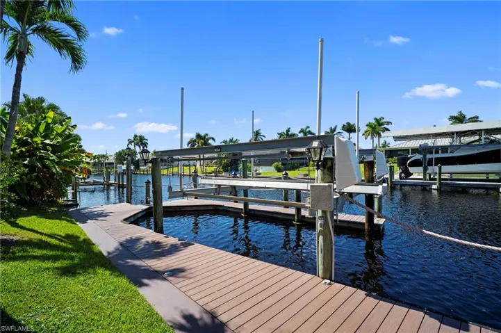 Dock with boat lift and a water view