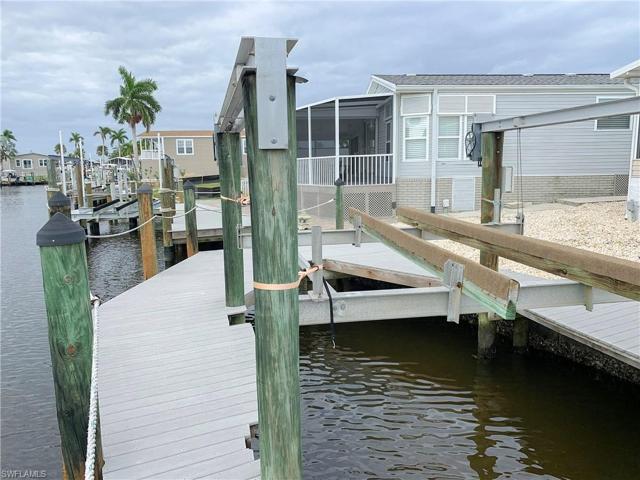 Beautiful composite, captain's walk dock with lift and fish cleaning station