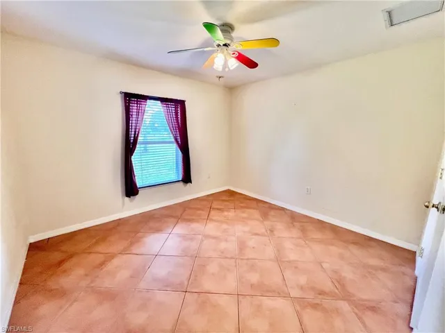 Guest bedroom with tiled floors.