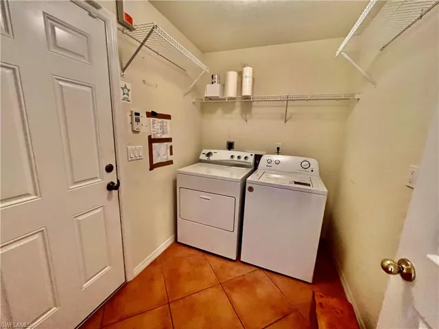 Laundry room with washing machine and clothes dryer.