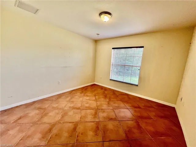 Guest bedroom with tiled floors.