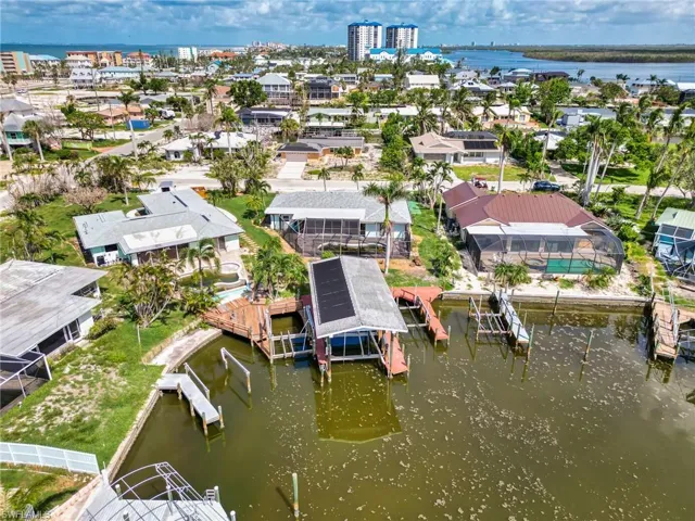 View from Water of House and docks Notice the solar pool heater panels