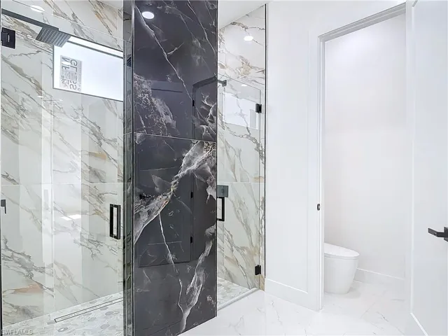 Bathroom with toilet and an enclosed shower