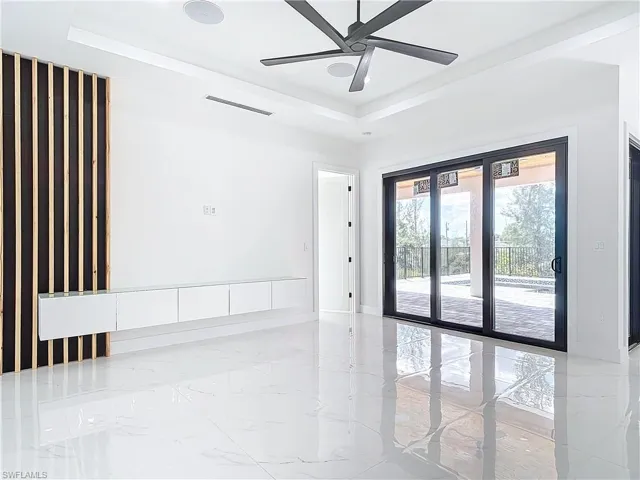 Spare room featuring ceiling fan and a raised ceiling