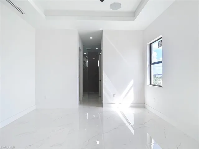 Unfurnished room featuring a raised ceiling