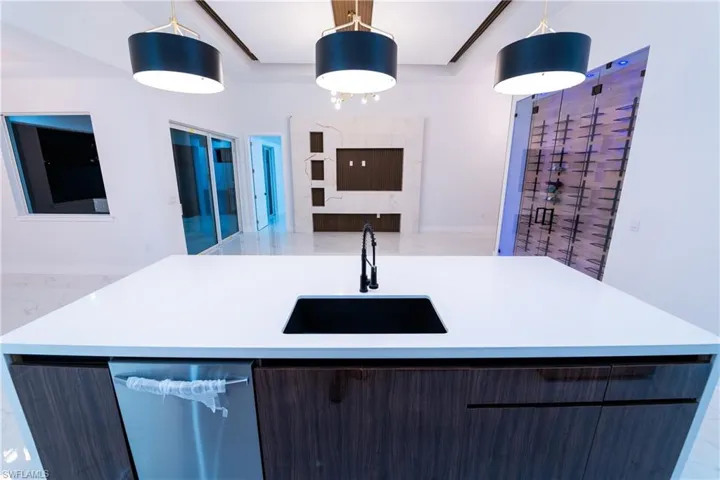 Kitchen featuring pendant lighting, sink, and a center island with sink