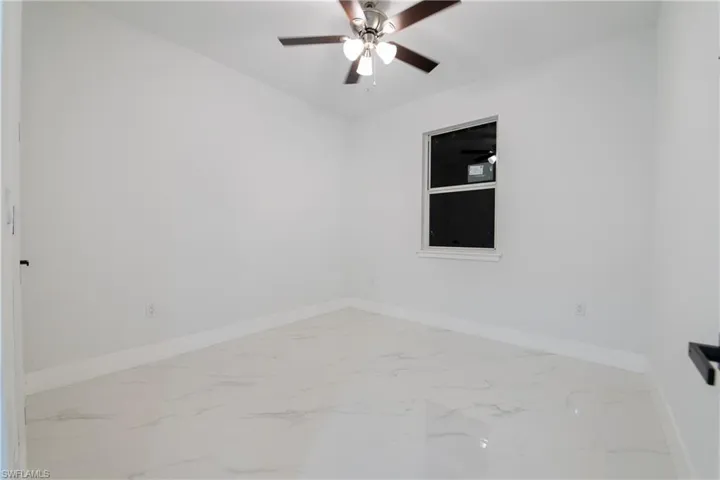 Spare room with ceiling fan