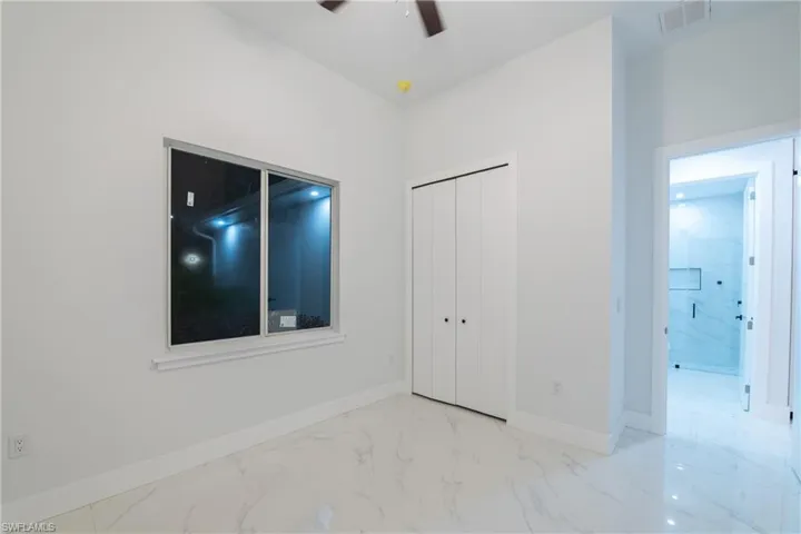Unfurnished bedroom featuring a closet and ceiling fan