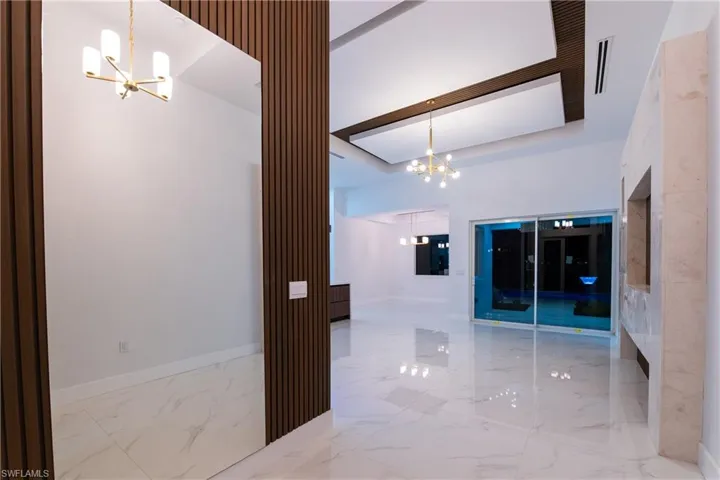 Hall featuring a notable chandelier