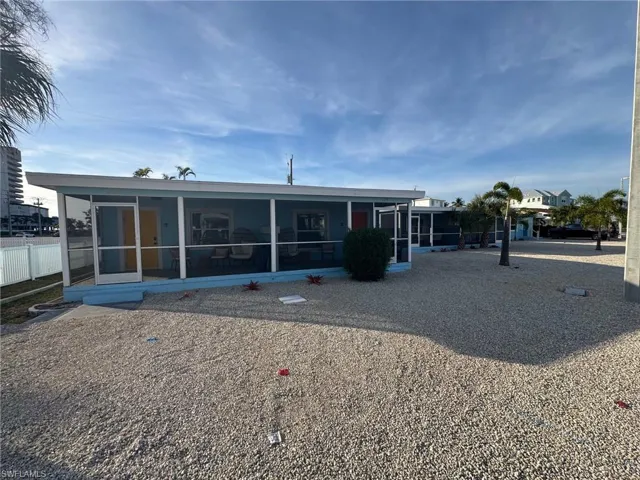 Back of house with a sunroom