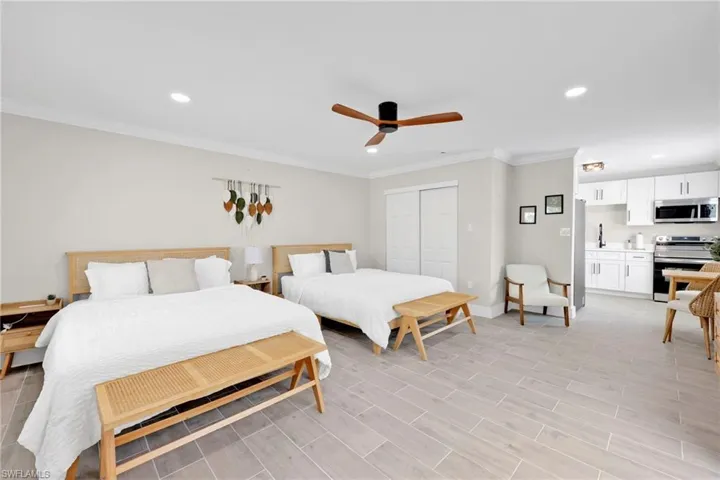 Bedroom featuring crown molding, a closet, recessed lighting, ceiling fan, and wood tiled floors