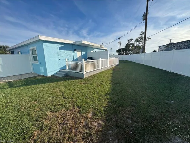 Back of house featuring a fenced backyard, a wooden deck, and stucco siding