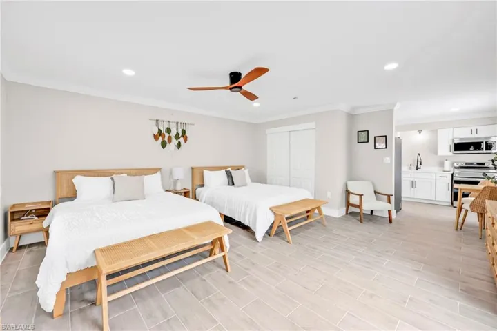 Bedroom featuring ornamental molding, recessed lighting, a closet, a ceiling fan, and light wood-style flooring