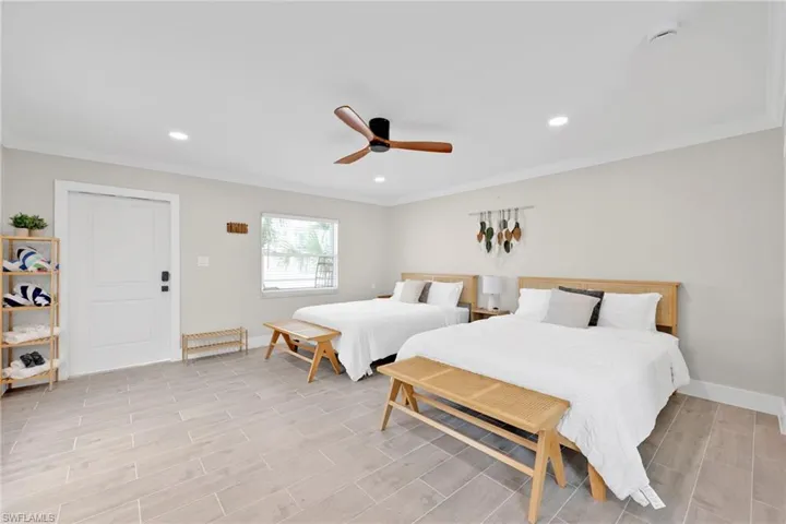 Bedroom featuring ornamental molding, wood tiled floors, ceiling fan, and recessed lighting
