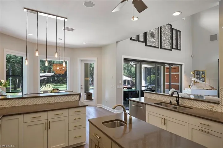 Kitchen with ceiling fan, sink, cream cabinetry, dishwasher, and light wood-type flooring
