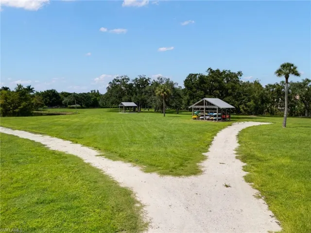 View of property's community with a lawn
