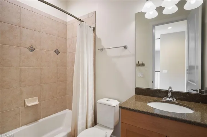 Upstairs Full bathroom with shower/bath combination with curtain, vanity, and toilet