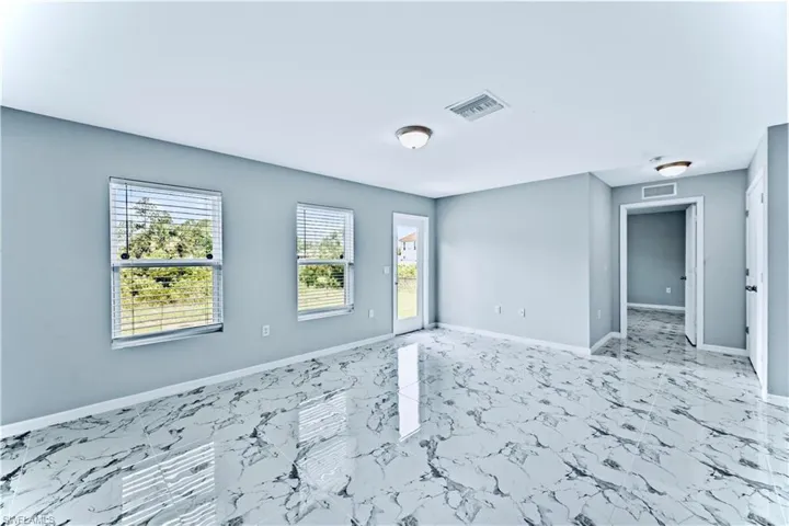 Spare room featuring light tile floors