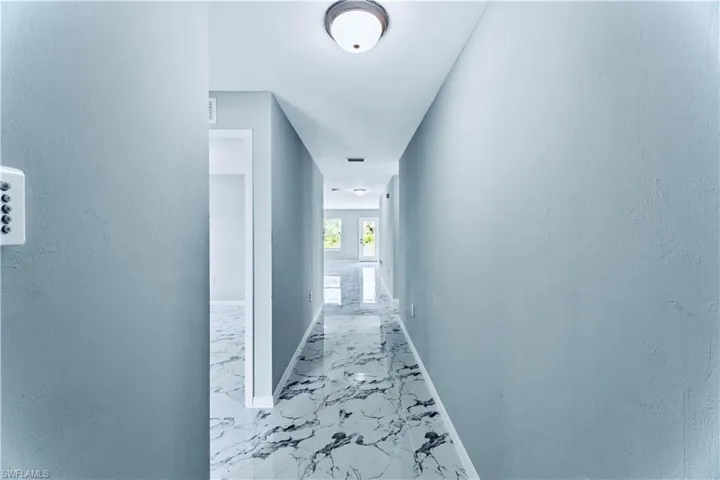 Corridor with light tile floors