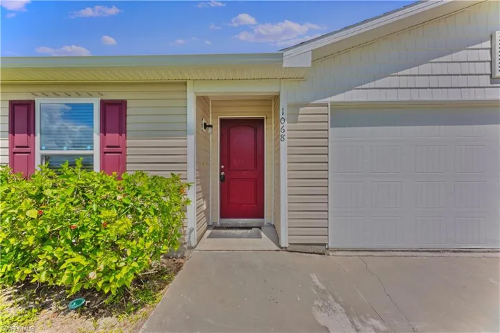View of exterior entry featuring a garage