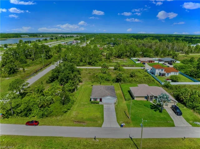 Birds eye view of property with a water view