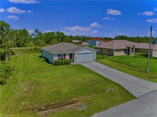 Ranch-style house with a front lawn and a garage