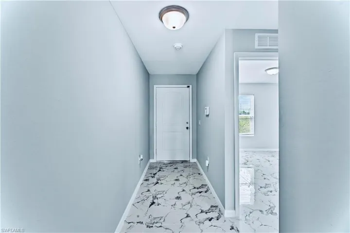 Corridor with light tile flooring