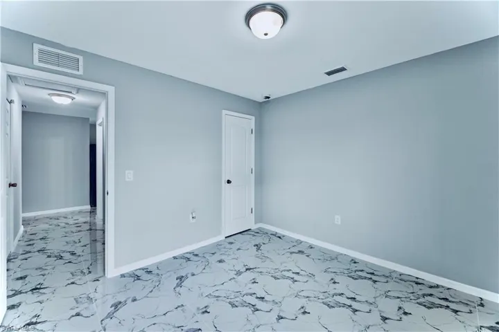 Unfurnished room featuring tile floors