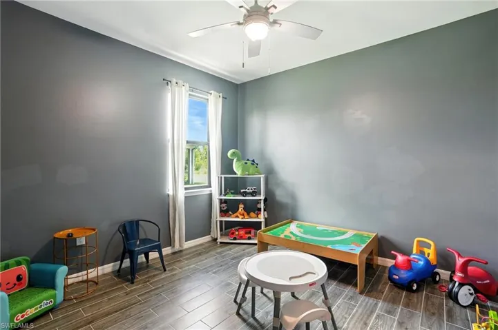 Game room featuring wood finish floors and ceiling fan