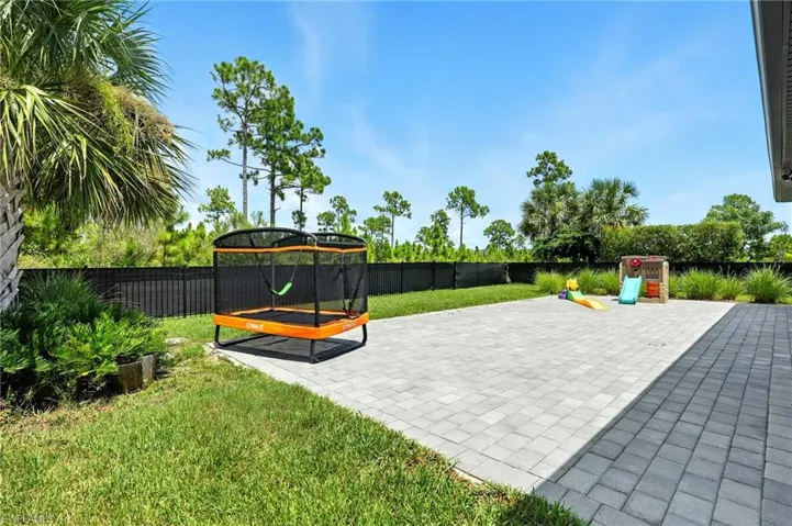 Surrounding community with a fenced backyard and a patio