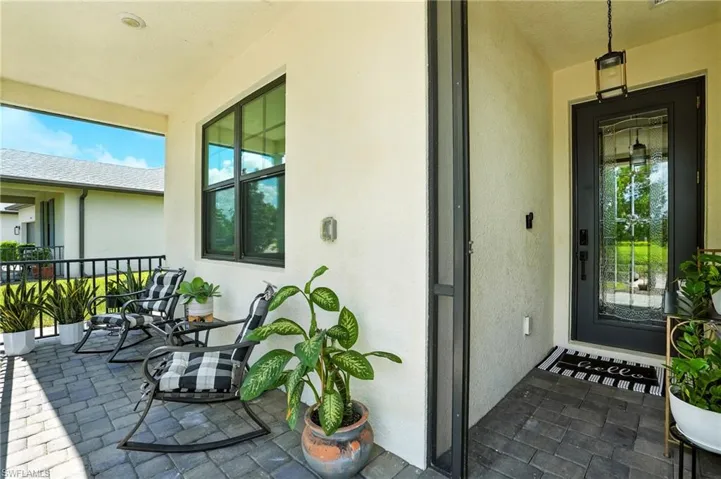 Entrance to property featuring stucco siding and a patio