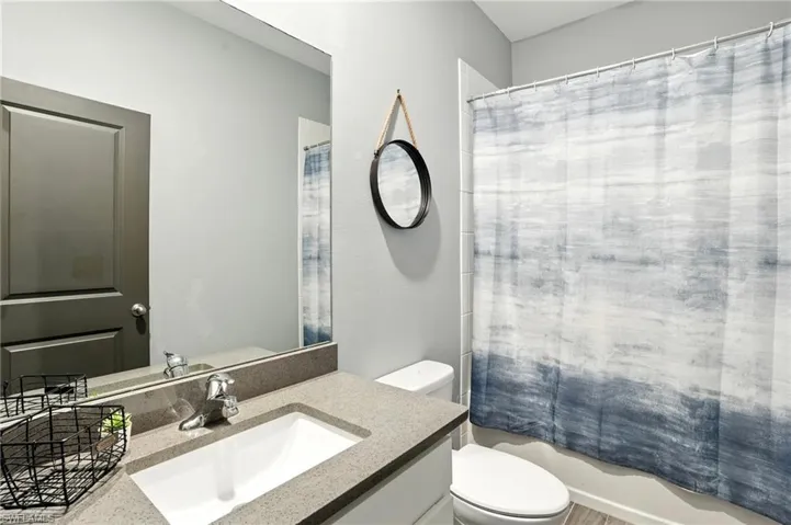 Full bathroom featuring vanity and shower / bath combo with shower curtain