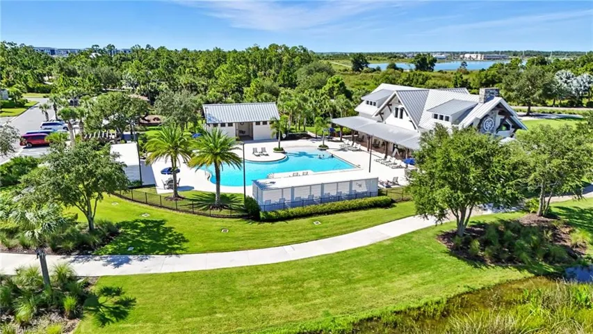 Aerial view of a pool area and a tree filled landscape