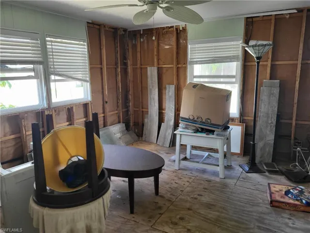 Sitting room with plenty of natural light and ceiling fan