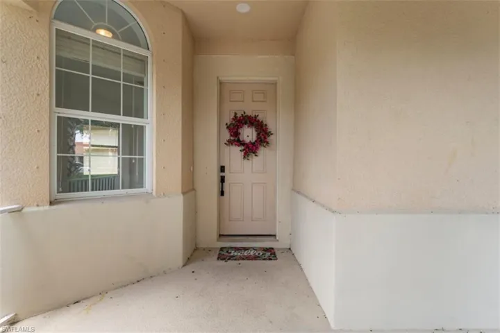 Doorway to property featuring stucco siding