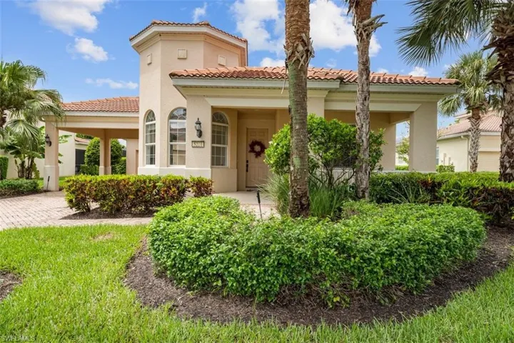 View of front of home featuring a tiled roof and stucco siding