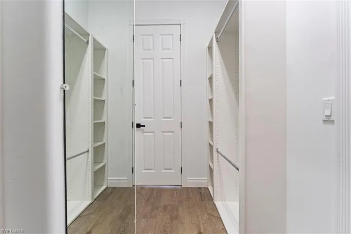 Walk in closet featuring wood finished floors