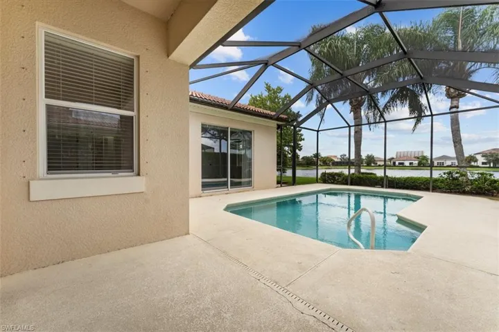 Swimming pool with a patio and large screened-in lanai