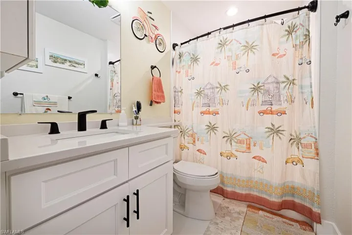 Bathroom with vanity and a shower with shower curtain