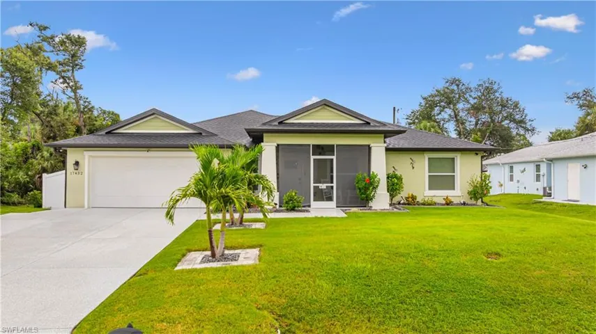 Ranch-style home with a garage, a front yard, concrete driveway, and stucco siding