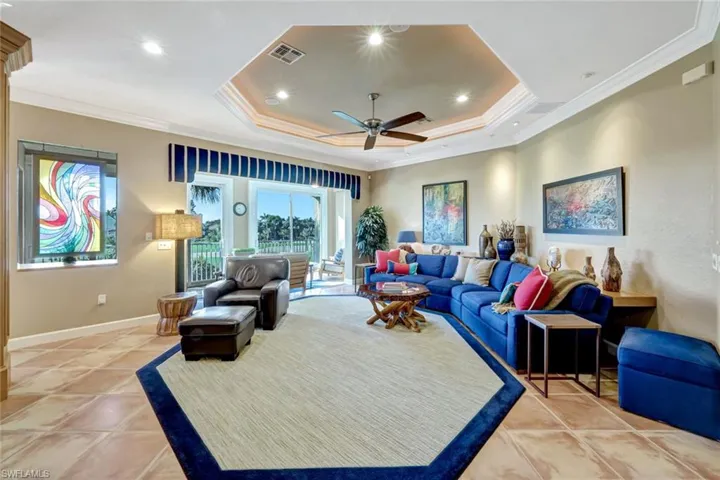 Living area featuring crown molding and raised Octagonal Ceiling