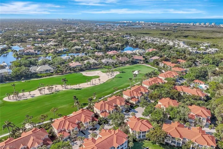 Drone / aerial view with a water view, a residential view, and golf course view