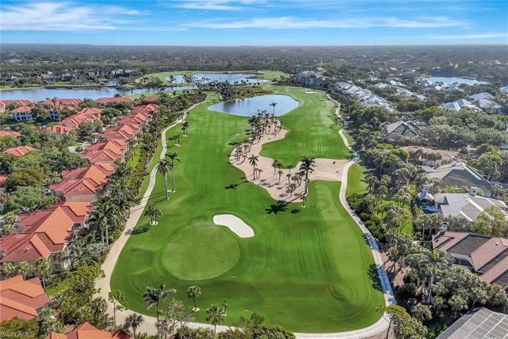 Drone / aerial view with view of golf course, a residential view, and a water view