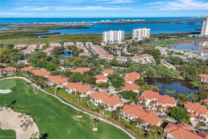 Aerial view featuring golf course view and a water view