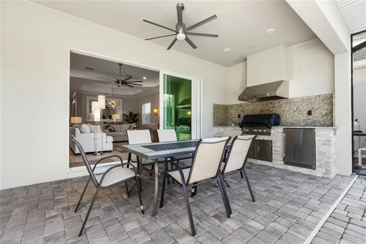 View of patio / terrace with ceiling fan and area for grilling