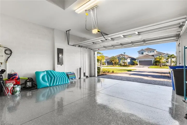 Garage featuring a garage door opener and electric panel