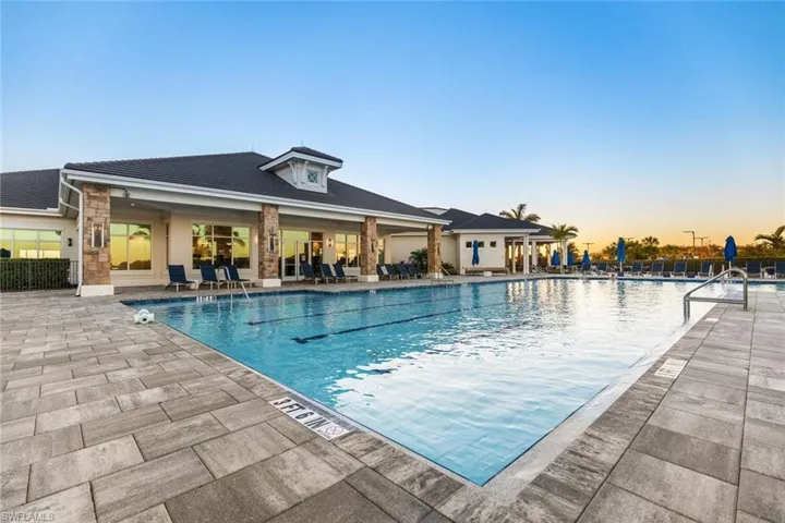 Pool at dusk with a patio and central AC