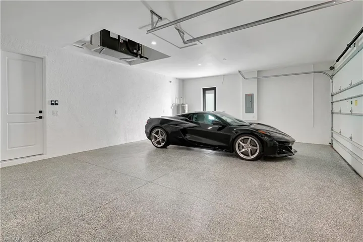 Garage featuring a textured wall and electric panel
